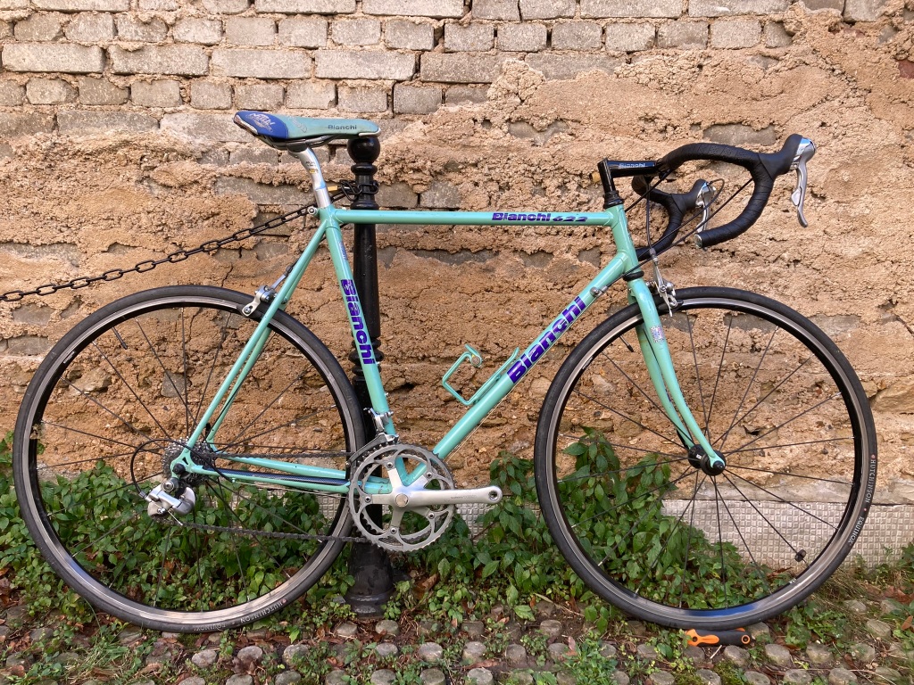 Vélo de course le long d'un mur, couleur bleu-vert, de marque Bianchi